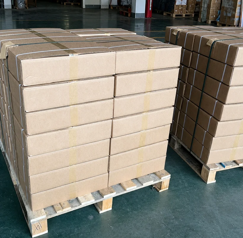 Cartons secured with straps on wooden pallets
